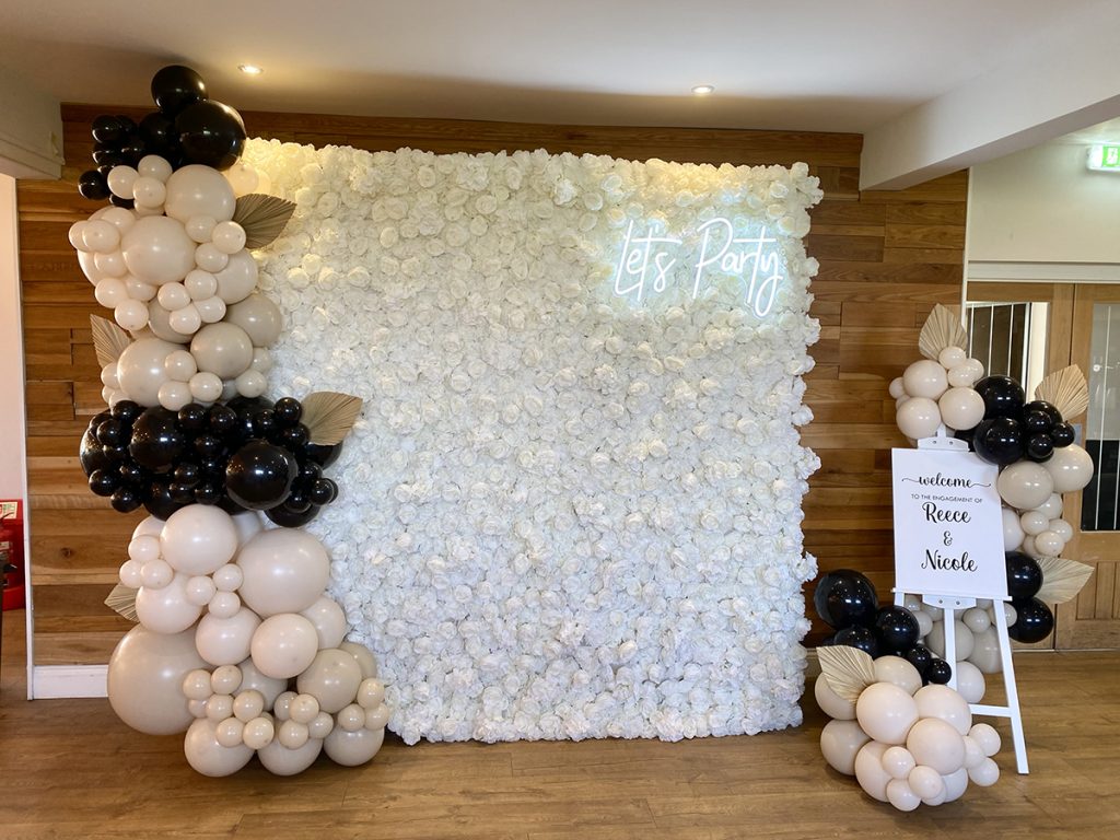 Lets PArty flower wall engagement entrance